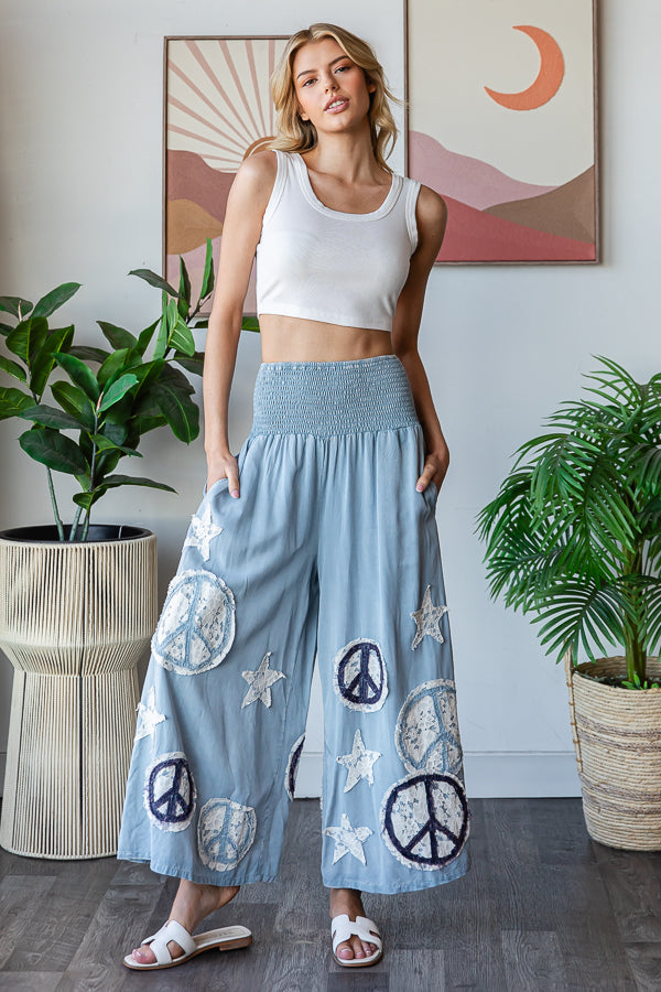 WASHED SMOCKED PEACE AND STAR PATCHWORK PANTS