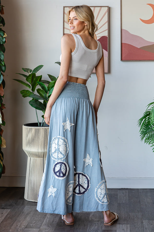 WASHED SMOCKED PEACE AND STAR PATCHWORK PANTS