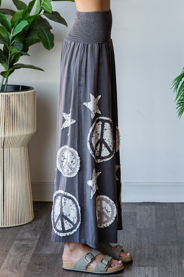 WASHED SMOCKED PEACE AND STAR PATCHWORK PANTS