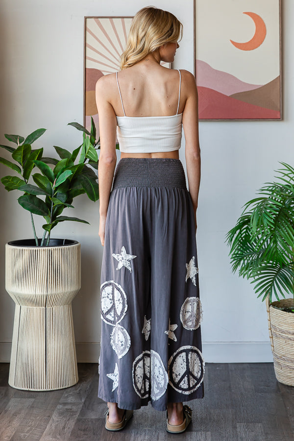 WASHED SMOCKED PEACE AND STAR PATCHWORK PANTS