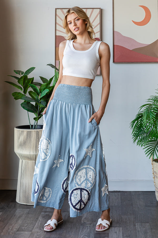 WASHED SMOCKED PEACE AND STAR PATCHWORK PANTS