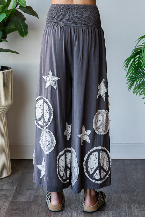 WASHED SMOCKED PEACE AND STAR PATCHWORK PANTS