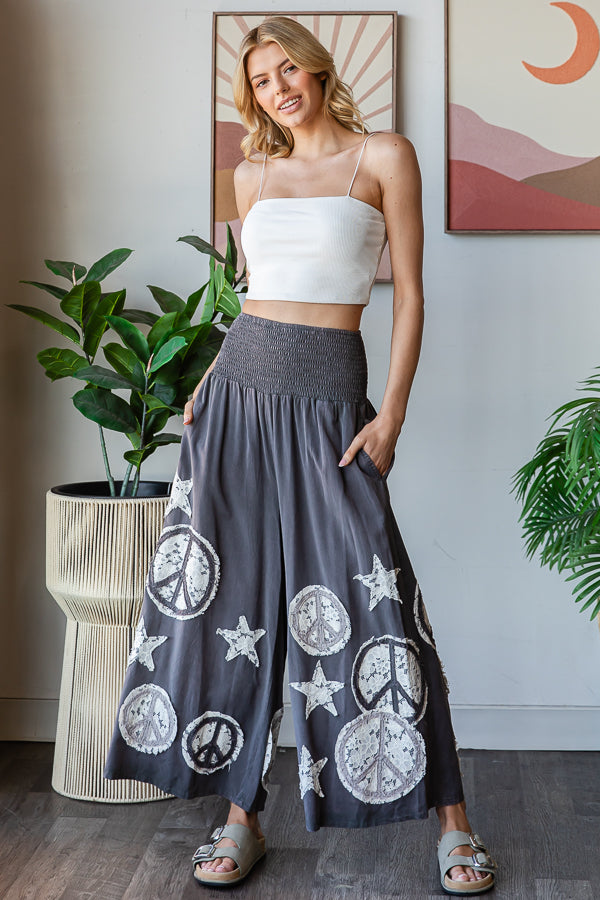 WASHED SMOCKED PEACE AND STAR PATCHWORK PANTS