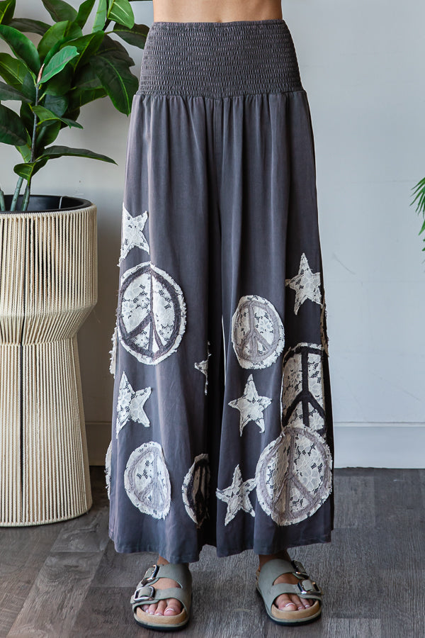 WASHED SMOCKED PEACE AND STAR PATCHWORK PANTS