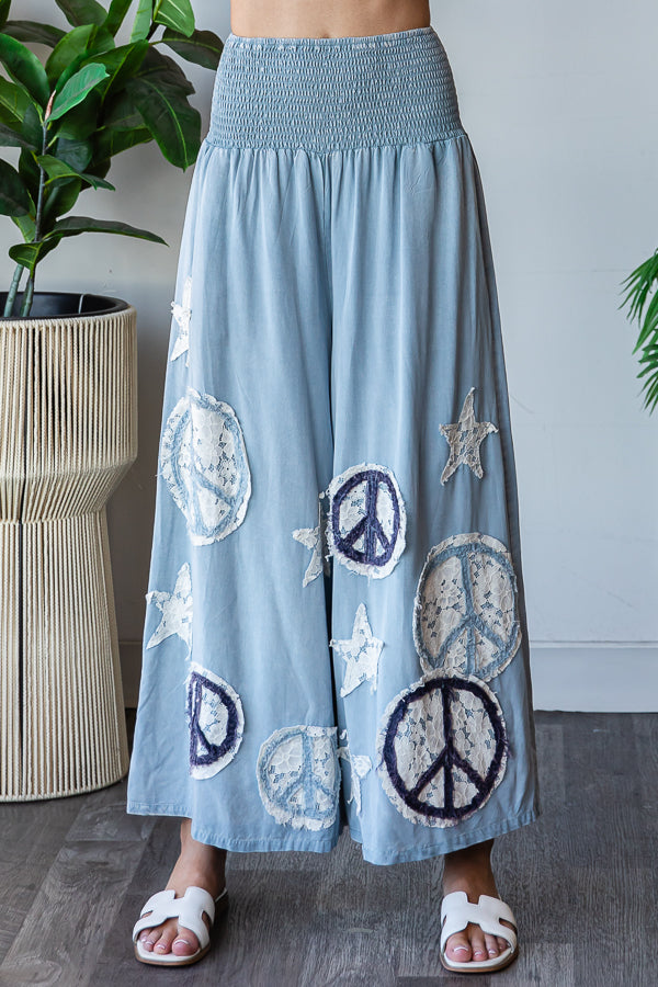 WASHED SMOCKED PEACE AND STAR PATCHWORK PANTS