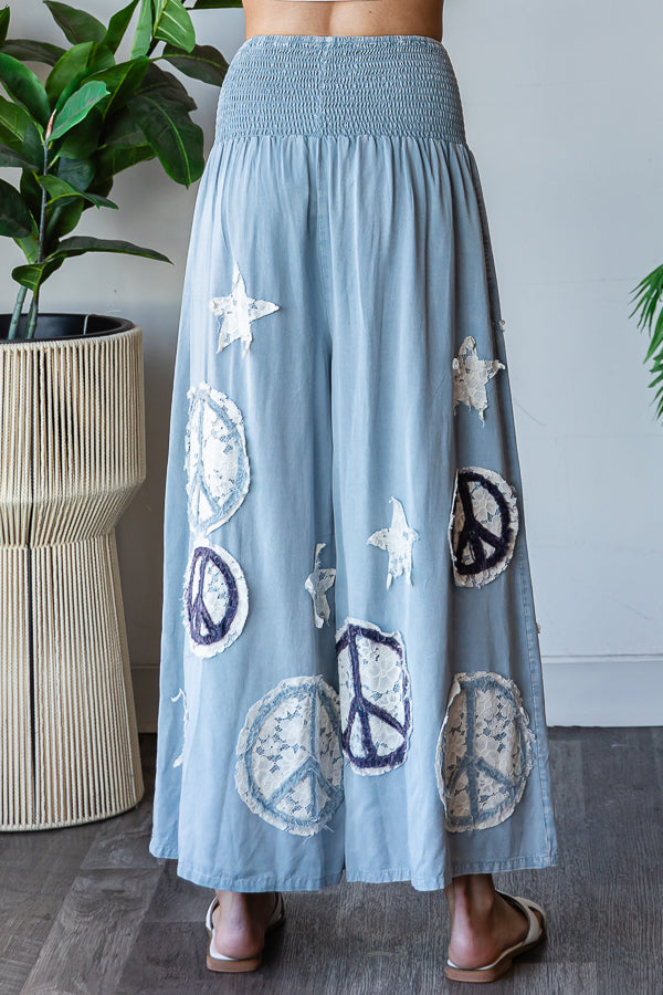 WASHED SMOCKED PEACE AND STAR PATCHWORK PANTS